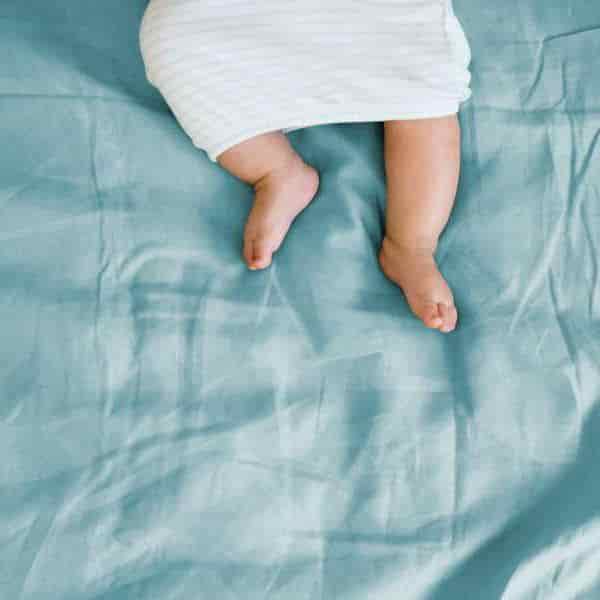 baby's feet on a blue sheet